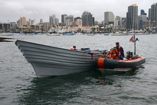 Crew members of U.S. Coast Guard Cutter Sea Otter tow a panga boat that was seized in a smuggling interdiction into San Diego Bay, Dec. 3, 2013. The crew of Coast Guard Cutter Active intercepted the panga with 5,000 pounds of marijuana and two suspects aboard approximately 140 miles southwest of San Diego. (U.S. Coast Guard photo by Petty Officer 1st Class Henry G. Dunphy)