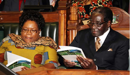 Republic of Zimbabwe President Robert Mugabe and Vice President Joice Mujuru reviewing the 2014 budget for the Southern African state. The budget was introduced in late December 2013. by Pan-African News Wire File Photos