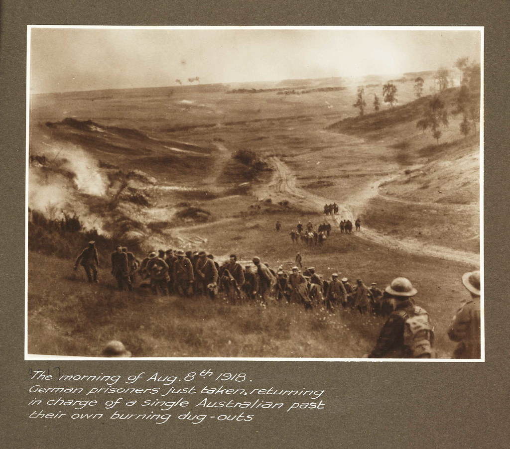 The morning of Aug.8th 1918. German prisoners just taken, returning in charge of a single Australian past their own burning dug-outs