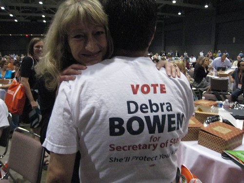 Debra Bowen hugging norm for wearing her tee shirt