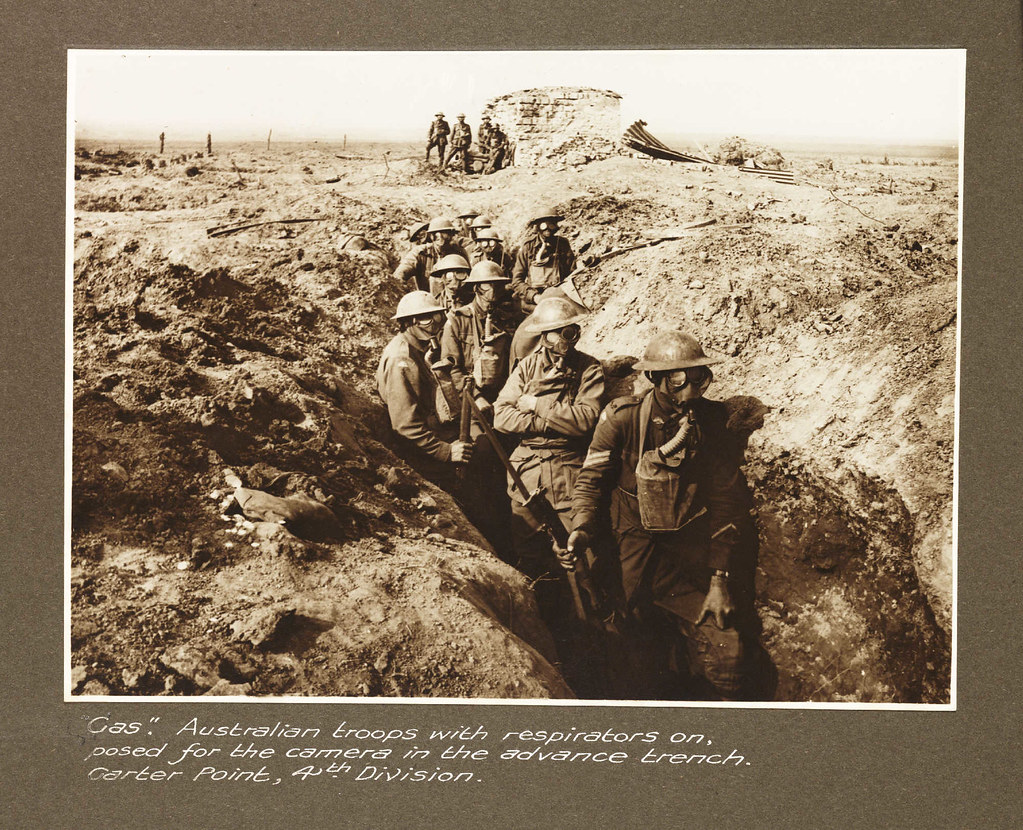 "Gas." Australian troops with respirators on posed for the camera in the advance trench, Garter Point, 4th Division