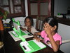 Sneha (age 2) and Aksheta (age 6) play with the OLPC one-laptop-per-child laptop in Wanica, rural Suriname