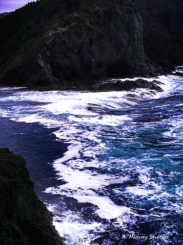 ocean blue mountain water newfoundland photography surf waves peaceful cliffs cave