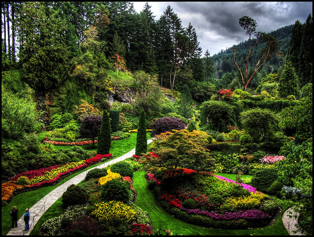Two people visit Butchart Gardens on a cloudy day and stand motionless long enough for a 5x HDR