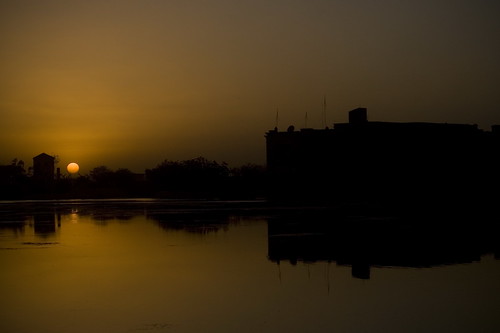 sunset sun water silhouette contrast buildings dark desert iraq