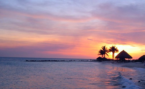 ocean pink sunset vacation sky beach water clouds marriott palms sand waves view casino palm resort palmtrees hut curacao emerald