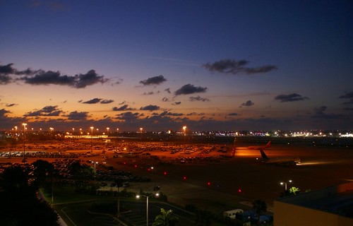 cloud beach plane sunrise airport view parking structure palm international pbi