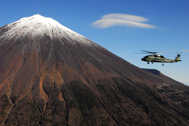 Helicopter flies by Mt. Fuji