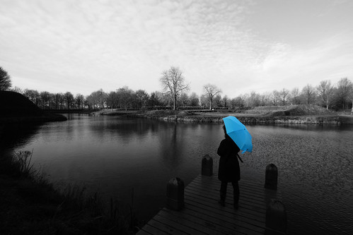travel blue light sky people blackandwhite bw woman color colour travelling tourism water netherlands girl dutch weather horizontal clouds umbrella landscape outdoors person photography one pier canal scenery december alone quiet view thenetherlands wideangle scene tourist serene lonely 2008 colouring channel selective bourtange selectivecoloring