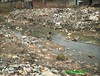 Child in open sewer in Nigeria