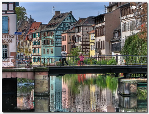 bridge houses windows roof people plants france reflection water colors girl architecture buildings reflections river restaurant wooden kid colours spectrum timber traditional strasbourg alsace bushes dri petitefrance hdr halftimber timberframed blueribbonwinner photomatix 3exp mywinners hdranything hdrvillage ruedemulins pontdufaisan mikegk:gettyimages=invited