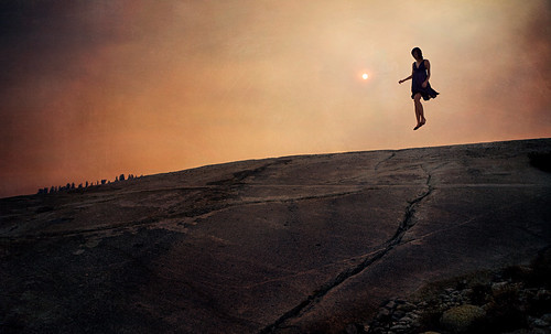trees sunset sky woman brown sun black mountains texture feet nature rock clouds dark fire person fly flying aftermath rocks driving wind body earth perspective dramatic floating surface dirt violence float cinematography treeline wildfire floatingpeople