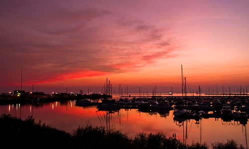 pink sunset sun color water silhouette clouds reflections boats lights pier lakeerie purple great lakes greatlakes reflect sail erie sailboats cloudformation milelongpier
