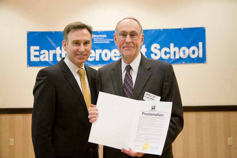 Dow Constantine and Bruce Laing with award