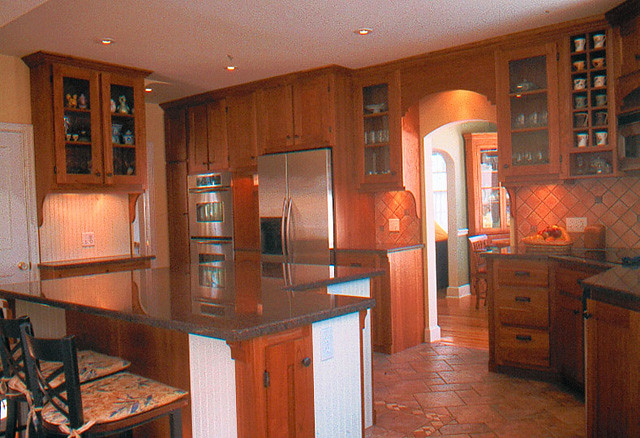 Large Cherry wood kitchen with oversized eat-in island.