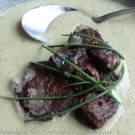 Potato soup with chives and blood sausage