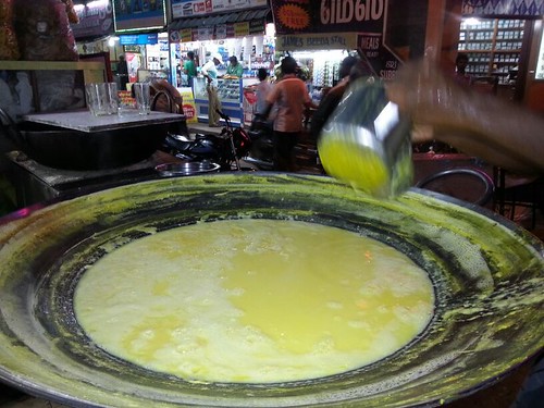 A street vendor using a special pot/pan for making Badam Milk and with special technique to serve it.