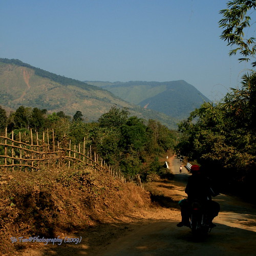 road travel people mountain tree forest canon fence asia state farm perspective motorcycle myanmar kachin earthasia