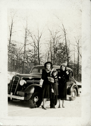two women, one child and car