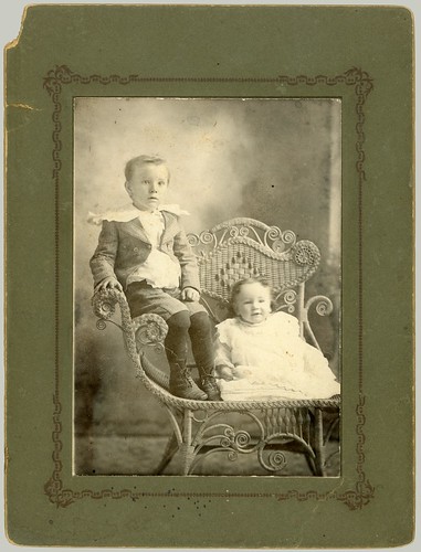 Two children and a one arm chair