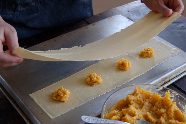 Laying down the top sheet of pasta dough