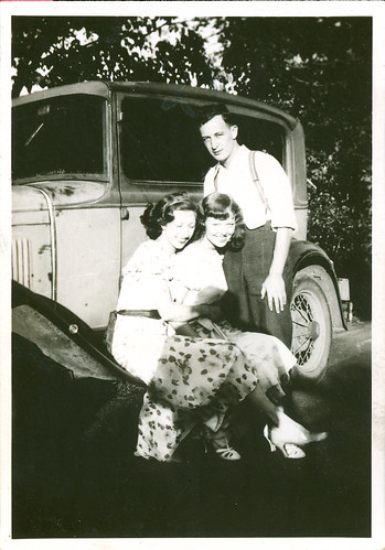 two girls, one guy and a car