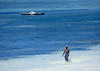 Veiled woman walking in the sea at Nungwi beach, Zanzibar, Tanzania