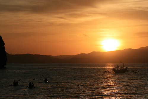 orange sunrise boats gold islands kayak palawan