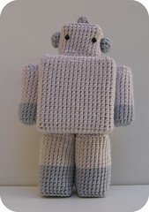 A crocheted toy robot.