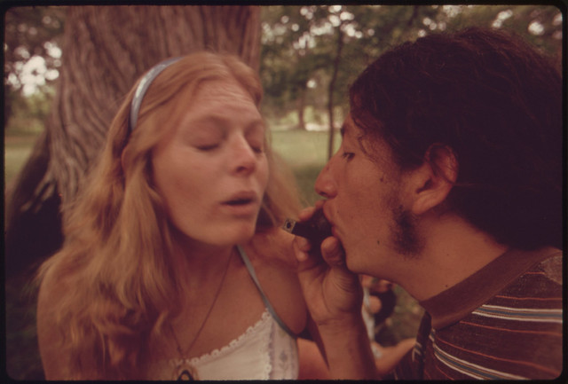 Boy and Girl Smoking Pot During an Outing in Cedar Woods near Leakey, Texas.