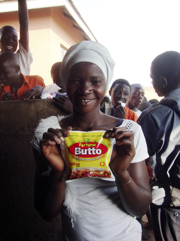 Ugandan woman holding Fortune Butto vegetable oil
