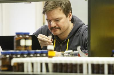 Researcher Andreas Keller smells the odor from a vial in this image.