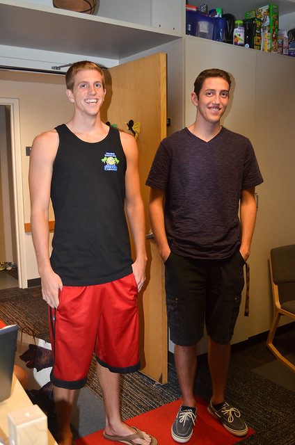 Two young men standing in a room.