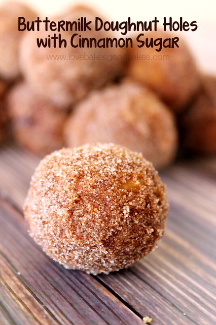 Buttermilk Doughnut Holes with Cinnamon Sugar piled up in the background with one doughnut hole close up.