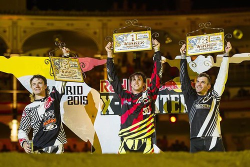 Tom Pagès of France celebrates his victory ahead of Levi Sherwood of New Zealand and Clinton Moore of Australia during the finals of the third stage of the Red Bull X-Fighters World Tour at the Plaza de Toros de Las Ventas in Madrid, Spain on July 10, 201