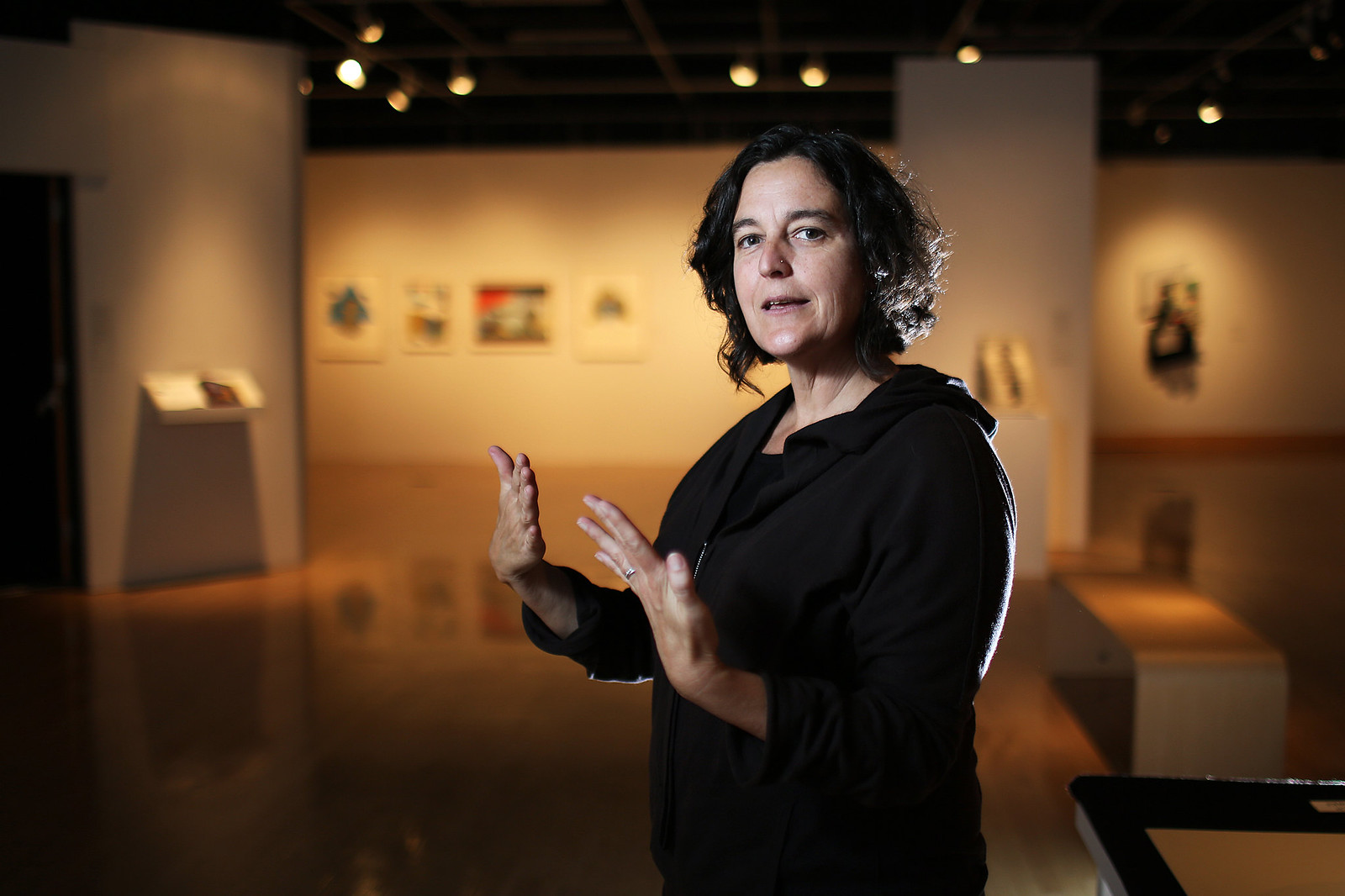 Sharon Bliss, curator for the SF State Gallery of Fine Art, stands in front of the 