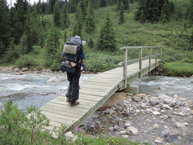 Crossing a wooden footbridge over Johnston Creek