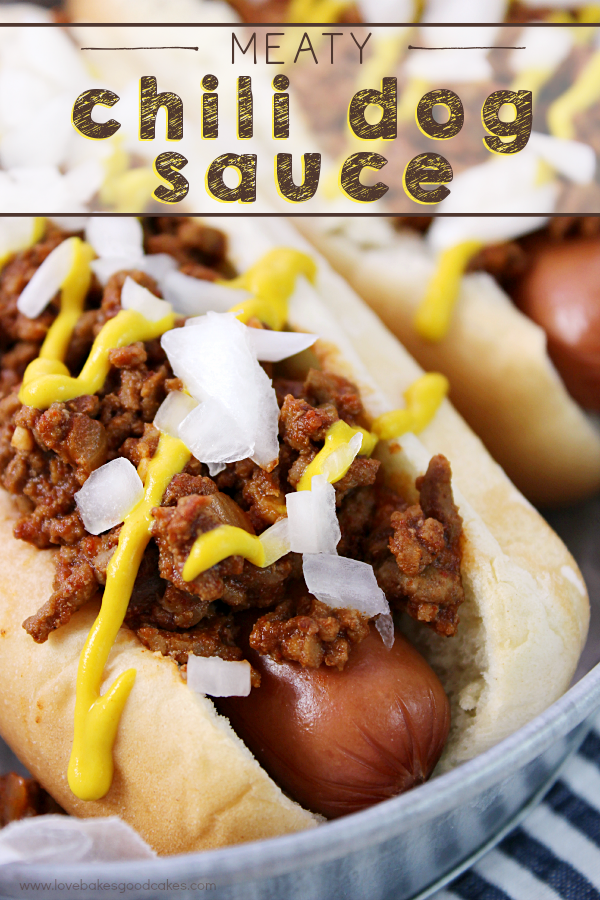 Meaty Chili Dog Sauce on a hot dog in a metal plate with chopped onions and mustard.