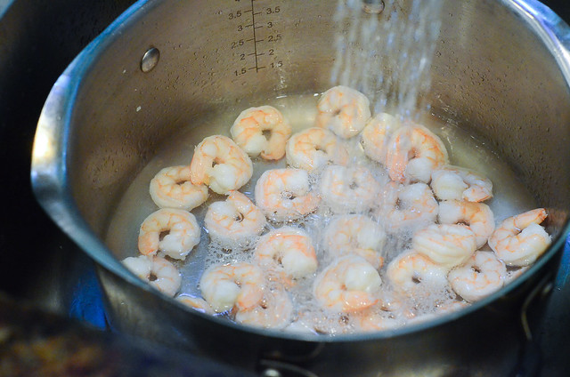 Cold water is sprayed on top of the cooked shrimp.