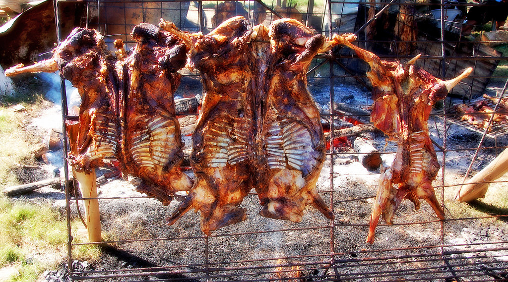 Whole animals are butterflied and slow barbecued over low flames and smoke