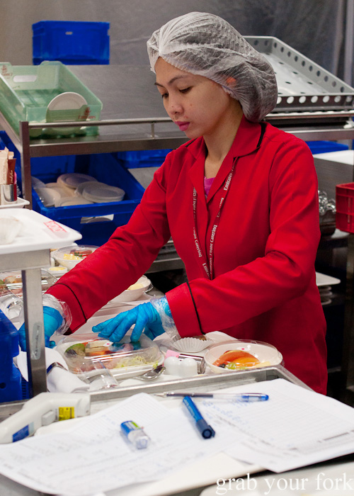 Plating Business Class meals during a behind-the-scenes tour of Emirates Flight Catering