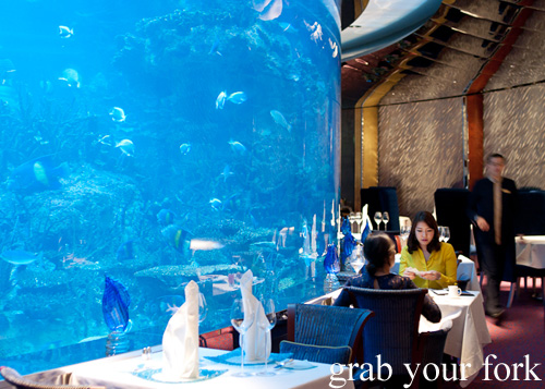 Diners by the giant aquarium at Al Mahara in Burj Al Arab, Dubai
