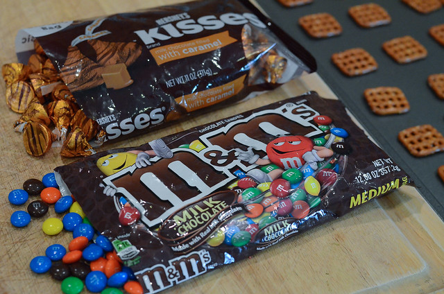 Open bags of M&Ms and Hershey's Caramel Kisses.