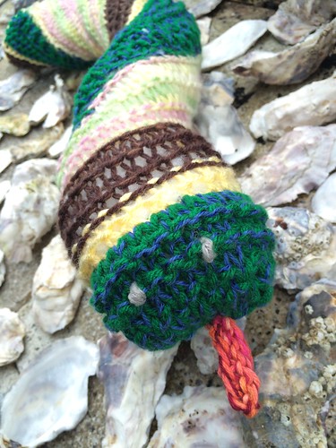 Knit striped toy snake from various swatches