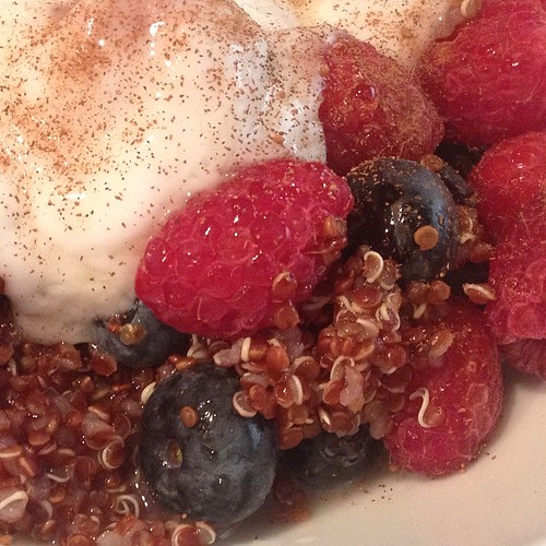 Red quinoa with berries, plain coconut yogurt, a dash of cinnamon, and a drizzle of maple syrup. So good! #plantstrong