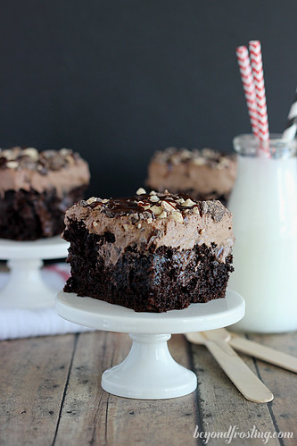 Sinful Triple Chocolate Poke Cake- loads of chocolate cake with chocolate whipped cream and added chocolate pudding soaked over the cake.