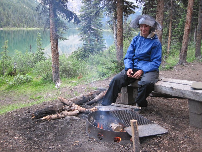 Vicki enjoying a mosquito-free campfire at Luellen Lake in the JO19 Campsite