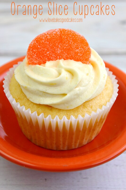 Orange Slice Cupcake in orange bowl with an orange candy on top.