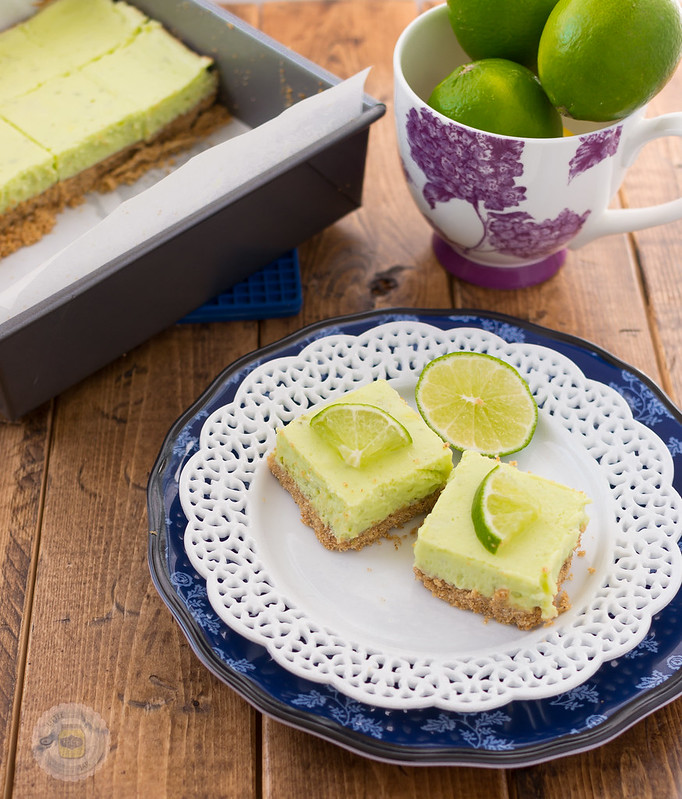 stacked plates with cut dessert squares with limes in mug