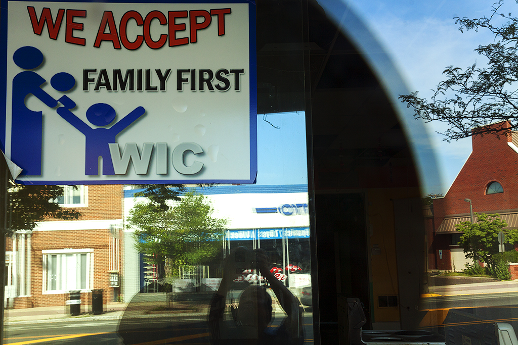 WE ACCEPT FAMILY FIRST WIC sign in window of out of business store--Woodbury
